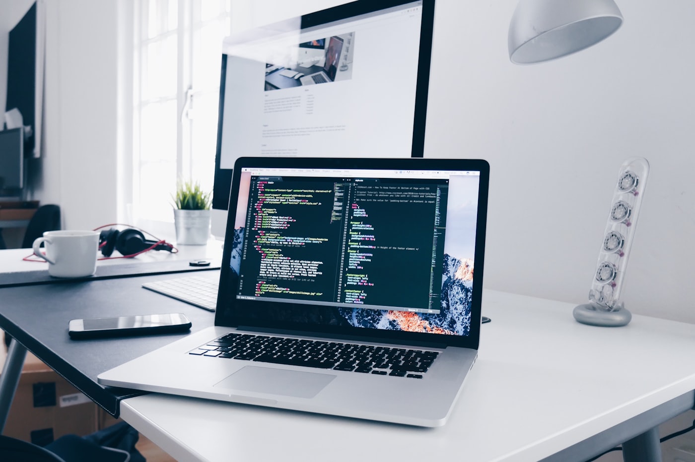 Developer building a website on a laptop in a modern workspace