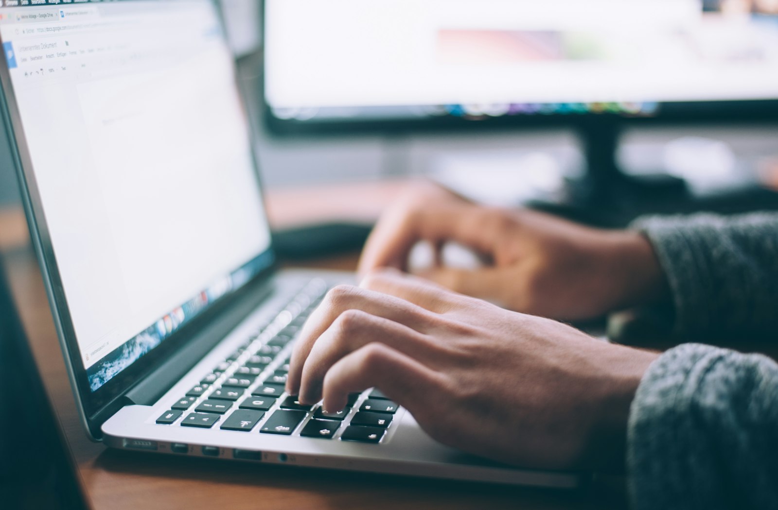 Hands typing on a laptop during DNS and SSL cut-over