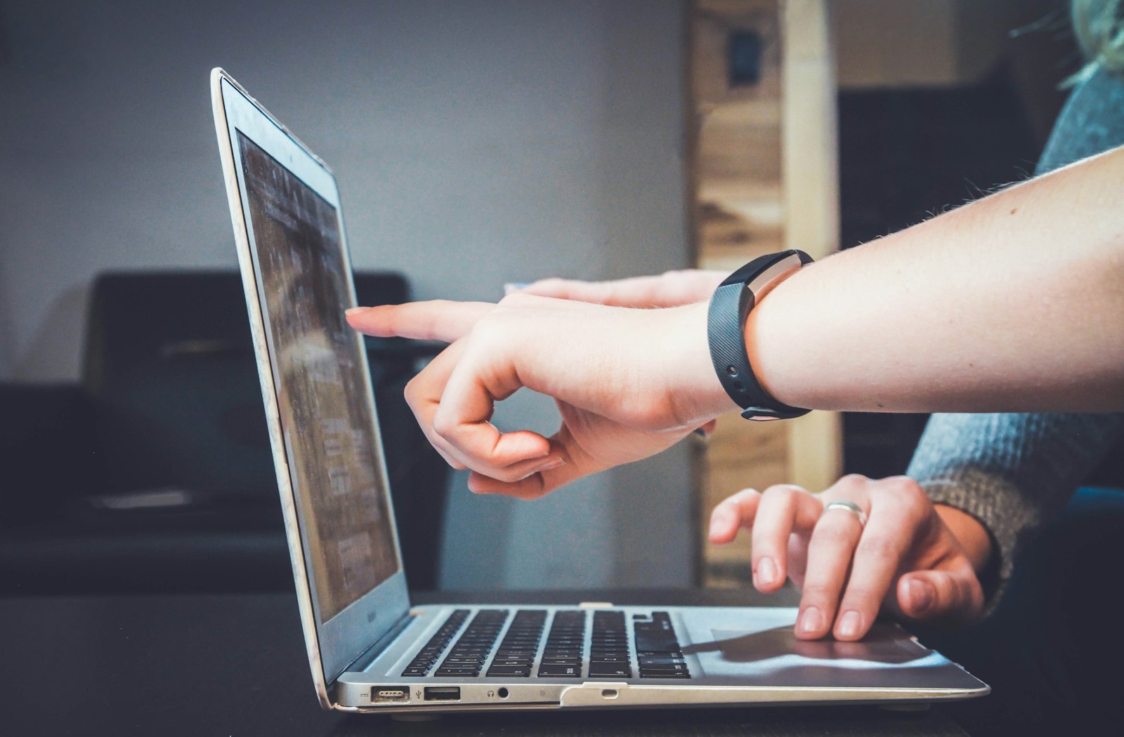 Two people reviewing a laptop screen before a website cut-over